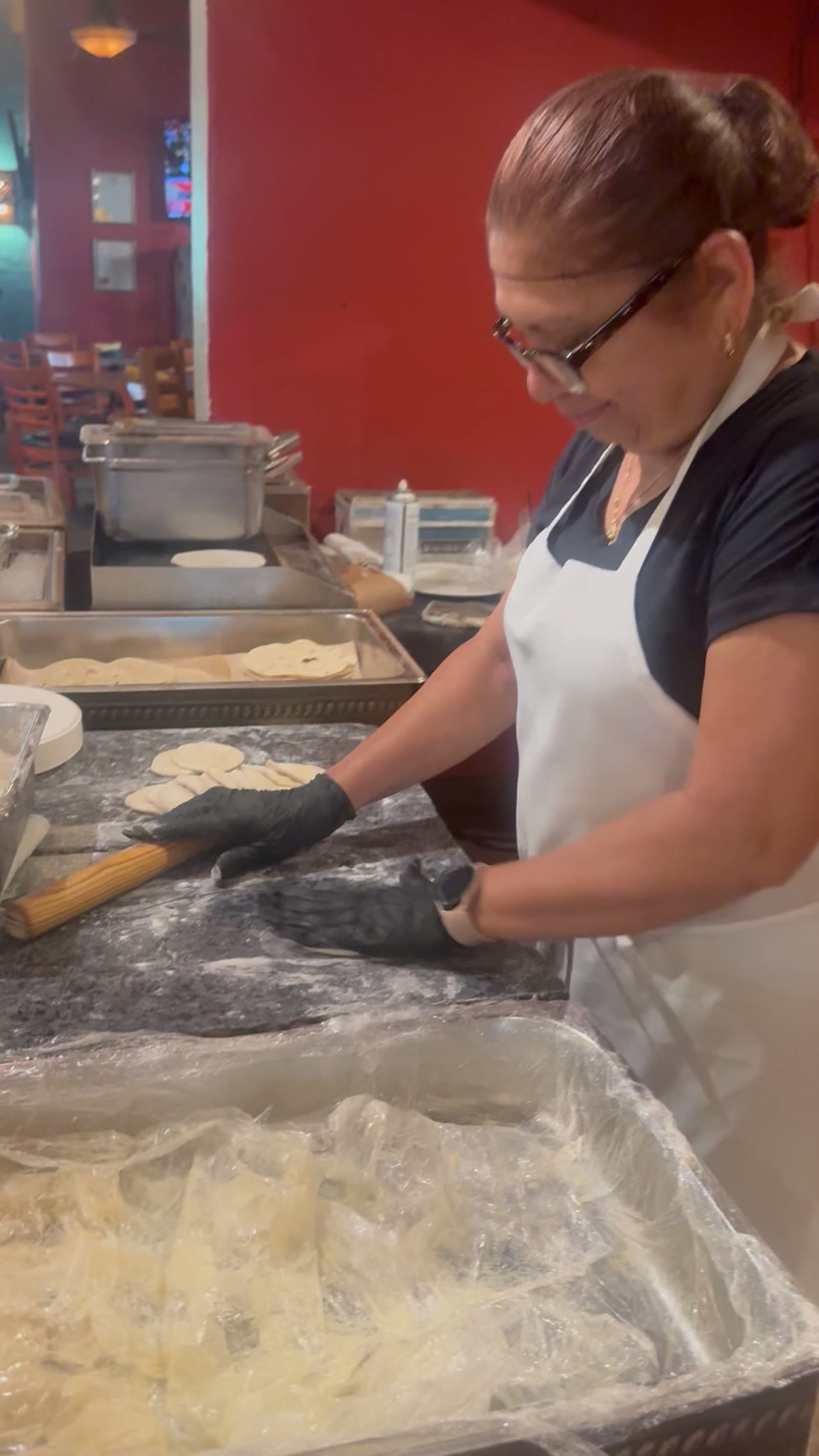 Our tortilla maker pressing fresh tortillas